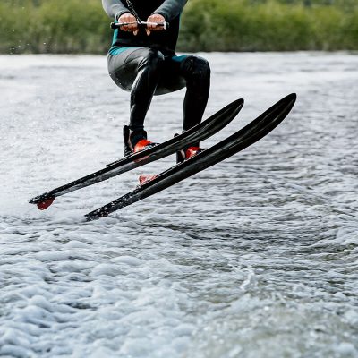 Man waterskiing on lake behind